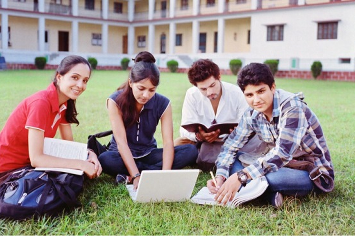 Students studying together on college lawn.