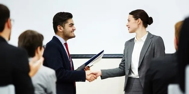 Two business professionals shaking hands in agreement.